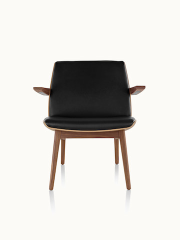 A low-back Clamshell Lounge Chair with black leather upholstery and four wood legs, viewed from the front.