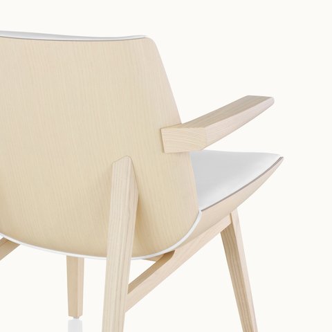 A high-back Clamshell Lounge Chair, viewed from behind at an angle to show the veneer shell.