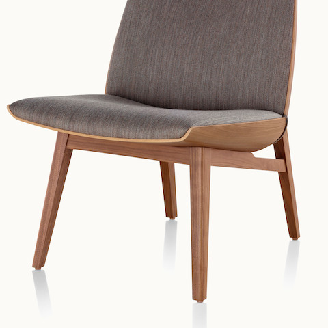 The lower portion of a low-back Clamshell Lounge Chair, showing the four solid wood legs.