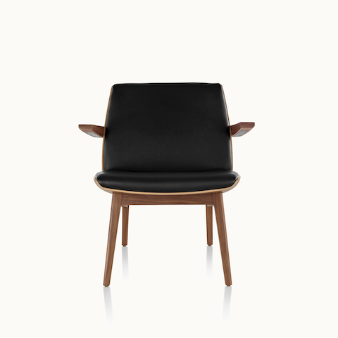 A low-back Clamshell Lounge Chair with black leather upholstery and four wood legs, viewed from the front.