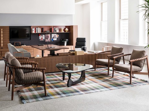 An executive office featuring Geiger Rhythm Casegoods along the back wall and a sitting area with four Crosshatch lounge chairs in the foreground.