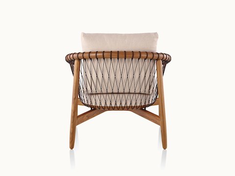 A Crosshatch lounge chair with linen-colored fabric and a wood frame in a medium finish, viewed from behind.