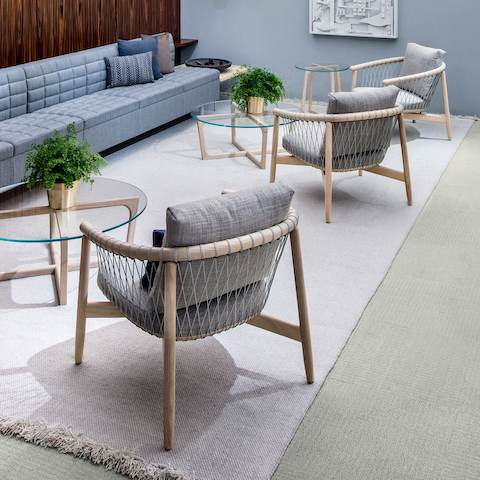 A casual meeting space featuring light gray Crosshatch lounge chairs and light blue Tuxedo Classic Lounge Seating.