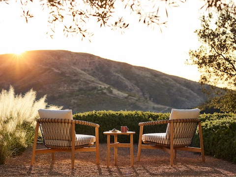 Crosshatch Outdoor Lounge Chairs and Trilobe Side Table in an environmental setting.