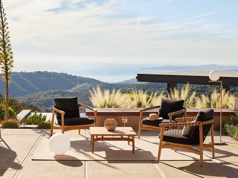 Crosshatch Outdoor Lounge Chairs and Square Coffee Table in an environmental setting overlooking mountain and ocean views.