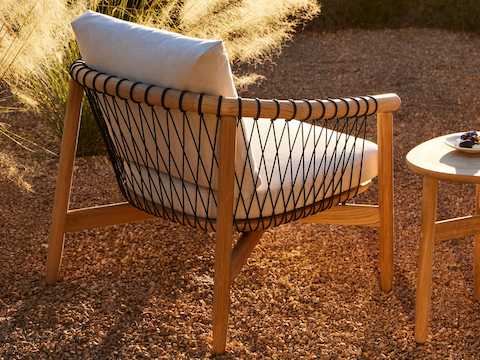 Crosshatch Outdoor Lounge Chair and Trilobe Side Table in an environmental setting. Crosshatch Outdoor Lounge Chair and Trilobe Side Table in an environmental setting.
