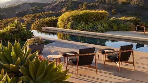 Crosshatch Outdoor Lounge Chairs with Ottomans in an environmental setting by the pool.