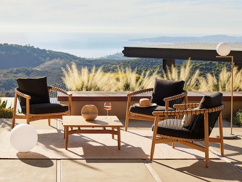 Crosshatch Outdoor Lounge Chairs and Square Coffee Table in an environmental setting overlooking mountain and ocean views.