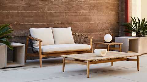 Crosshatch Outdoor Settee with Side Table and Rectangular Coffee Table in an environmental setting.