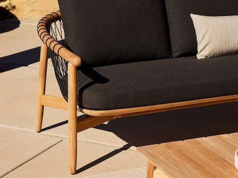 Crosshatch Outdoor Settee and Coffee Table in an environmental setting.