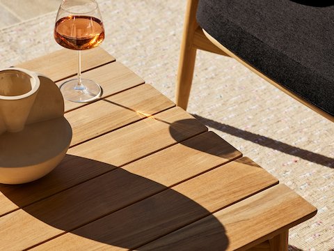 Crosshatch Outdoor Rectangular Coffee Table and Lounge Chair in an environmental setting.