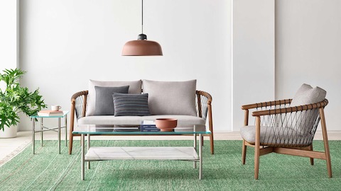 A casual lounge setting featuring a Crosshatch Settee, Crosshatch Chair, and Layer Tables.