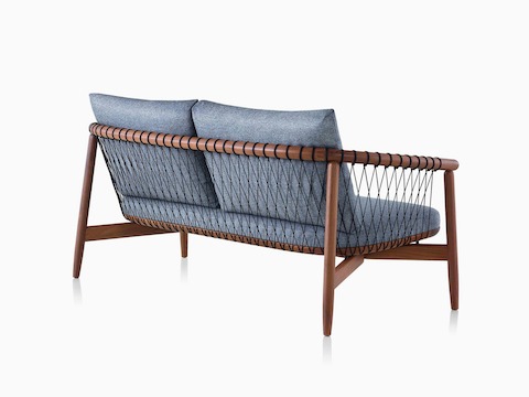 A dark-colored Crosshatch Settee featuring gray upholstery and a walnut frame. Viewed from behind at an angle.