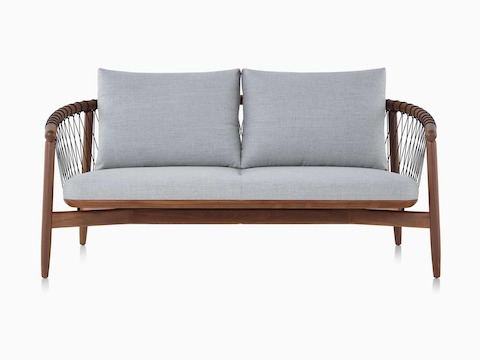 A Crosshatch Settee with a walnut frame, black cords, and light neutral fabric.