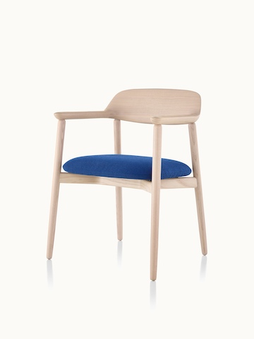 Angled view of a Crosshatch Side Chair with a blue fabric seat pad and a wood frame in a light finish.