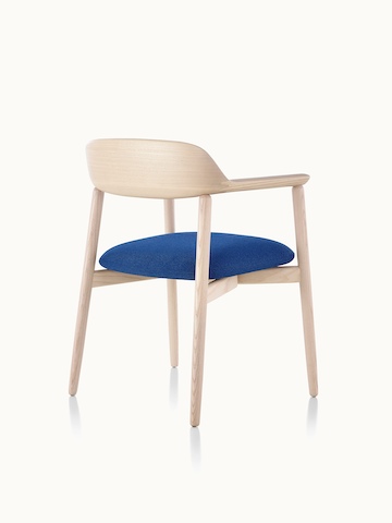 A Crosshatch Side Chair with a blue fabric seat pad and a wood frame in a light finish, viewed from behind at an angle.
