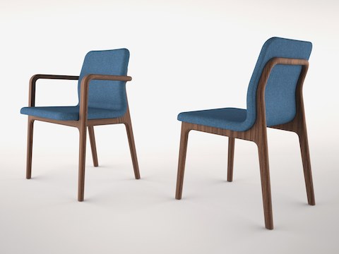 Angled view of two Deft side chairs with blue fabric, one with arms and one without.