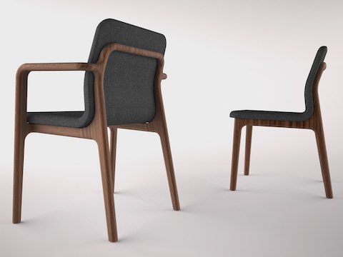 A Deft side chair with arms and black fabric, viewed from behind at an angle, next to an armless Deft side chair with black fabric, viewed from the side.