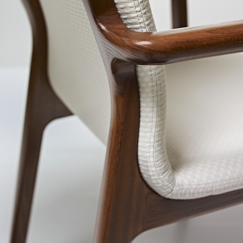 Close-up on a rear corner of a Deft side chair, showing the mortise-and-tenon wood joinery.