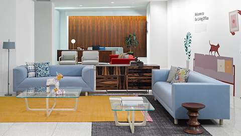 A lounge featuring a Domino Storage credenza between two light blue Rolled Arm Sofas.