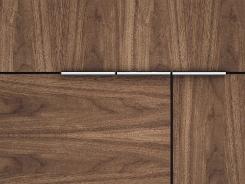 Close-up of a Domino Storage unit, showing three modules with a medium wood finish and a mix of grain direction.