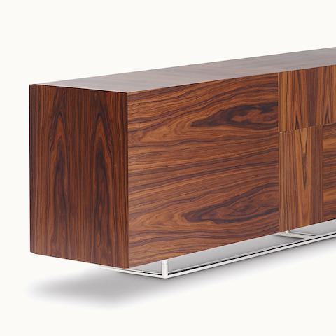 Partial angled view of a Domino Storage credenza with no visible hardware, showing a dark wood finish on all sides.