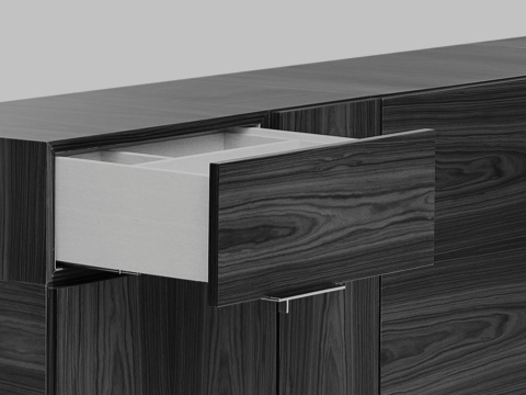 Black-and-white image of a portion of a Domino Storage credenza, showing one open drawer. Black-and-white image of a portion of a Domino Storage credenza, showing one open drawer.