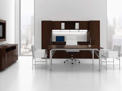 An executive office featuring two white leather Envelope side chairs facing each other across the narrow side of a rectangular desk.