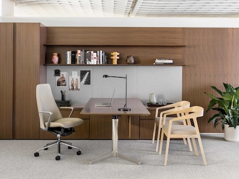 A private office featuring Geiger Levels Casegoods, a leather Taper executive chair, and two Full Twist Guest Chairs with wood frames in a light finish.