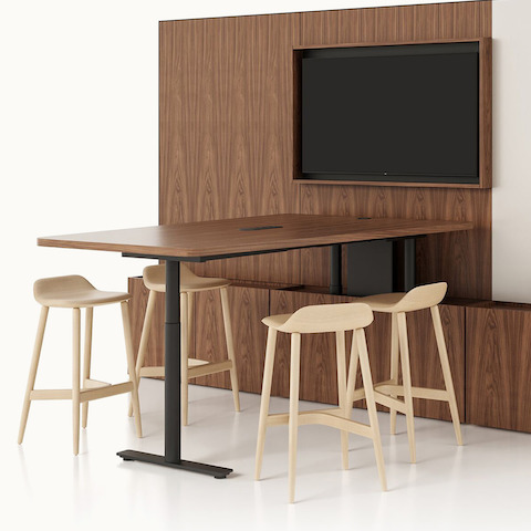 Geiger One Meeting and Huddle Room in Natural Walnut with Crosshatch Stools. Select to go to the Geiger One Meeting and Huddle Rooms product page.