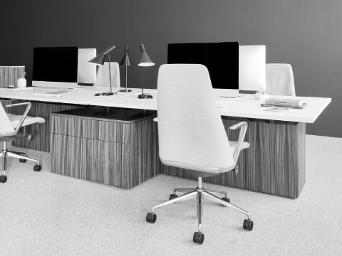 A bench system with four workstations featuring Geiger One Casegoods and Taper Chairs. A bench system with four workstations featuring Geiger One Casegoods and Taper Chairs.