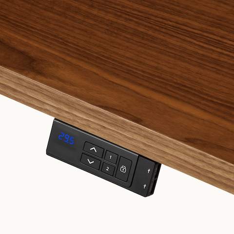 Detail shot of a Geiger One Casegoods sit-to-stand desk's height adjustable controller viewed from an angle.