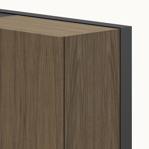 Detail shot of a Geiger One Casegoods wall frame in Natural Flat Cut Walnut and black metal viewed at an angle.