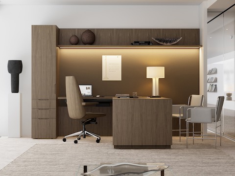 A Geiger One Private Office in Natural Flat Cut Walnut with a Clamshell Office Chair and Envelope Guest Chairs viewed from the side.