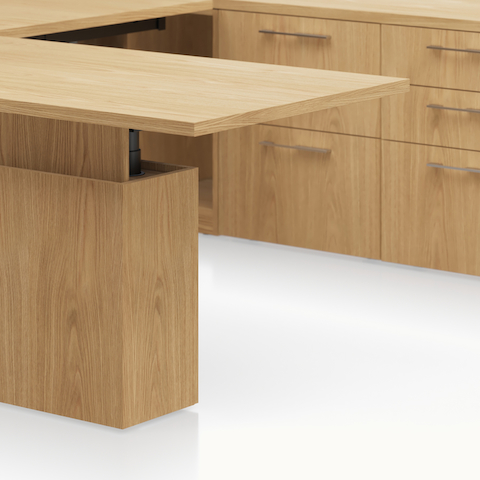 Detail shot of the Geiger One Casegoods runoff utility cabinet leg option in Natural Flat Cut Oak.