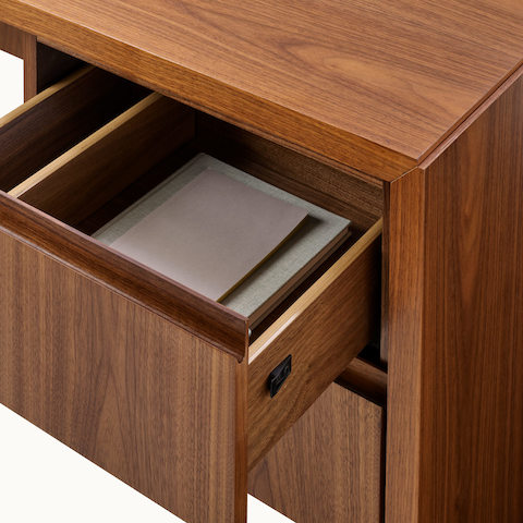 Geiger One Casegoods mitered stand-alone desk with open drawer and styling.
