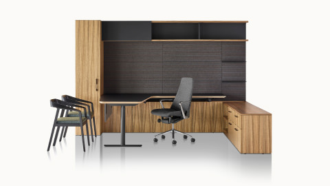 A private office featuring Geiger One Casegoods with a peninsula work surface and storage, a Taper office chair, and two Full Twist Guest Chairs.