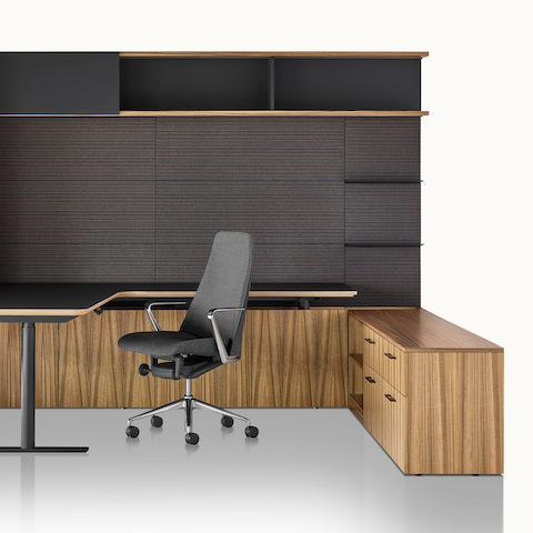 A private office featuring Geiger One Casegoods with a peninsula work surface and storage, a Taper office chair, and two Full Twist Guest Chairs. Select to go to the Geiger One Private Office product page.