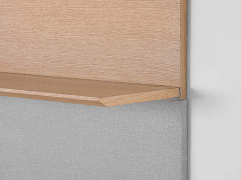 Close-up of the edge of a Geiger Shelf System shelf in a light rift oak finish, showing the premium wood veneer.