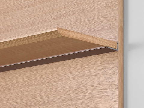 Close-up of the underside of a Geiger Shelf System shelf in a light rift oak finish, showing the hidden fasteners.