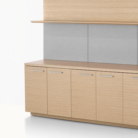 Partial angled view of a Geiger Shelf System with open and closed storage in a light rift oak finish.