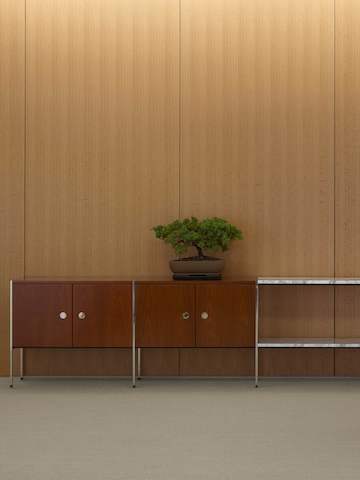 Partial view of an H Frame Storage credenza with enclosed cabinets and open shelving modules.