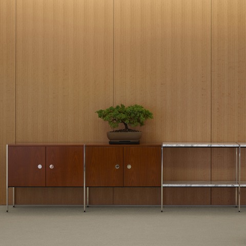 Partial view of an H Frame Storage credenza positioned against a wall.