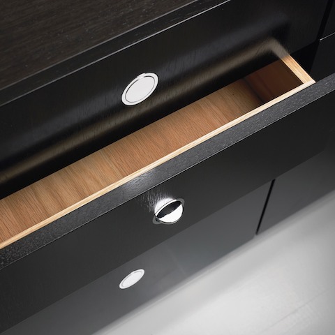 Overhead view of a partially open drawer in an H Frame Storage credenza, showing the flush-mounted Flip pulls.