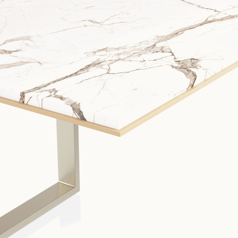 Edge detail shot of Highline Conference Table by DatesWeiser in Calacatta Gold Stone with leather edge and Satin Nickel base.