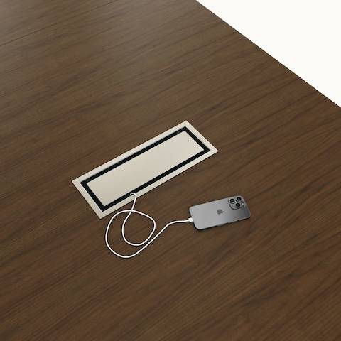 Detail shot of closed tabletop power access Highline Conference Table by DatesWeiser in Cashmere Flat Cut Walnut with Satin Nickel details.