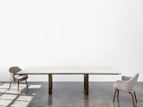 Highline Conference Table by DatesWeiser with White Wash Walnut top, Oil Rubbed Bronze Metal edge detail and open loop leg.