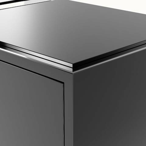 Edge detail shot of Highline Credenza by DatesWeiser in Black Polyester with Clear Black Backpainted Glass top.