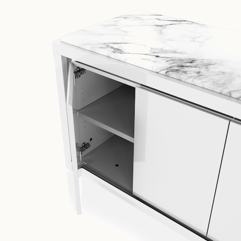 Detail shot of open hinged door on Highline Fifty Credenza by DatesWeiser in White Polyester with White Carrara Marble top and Polished Chrome Metal trim.