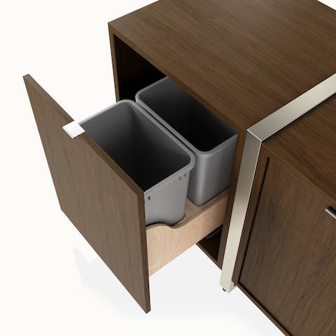 Detail shot of trash pullout drawer on Highline Credenza by DatesWeiser in Natural Flat Cut Walnut with Satin Nickel Legs.